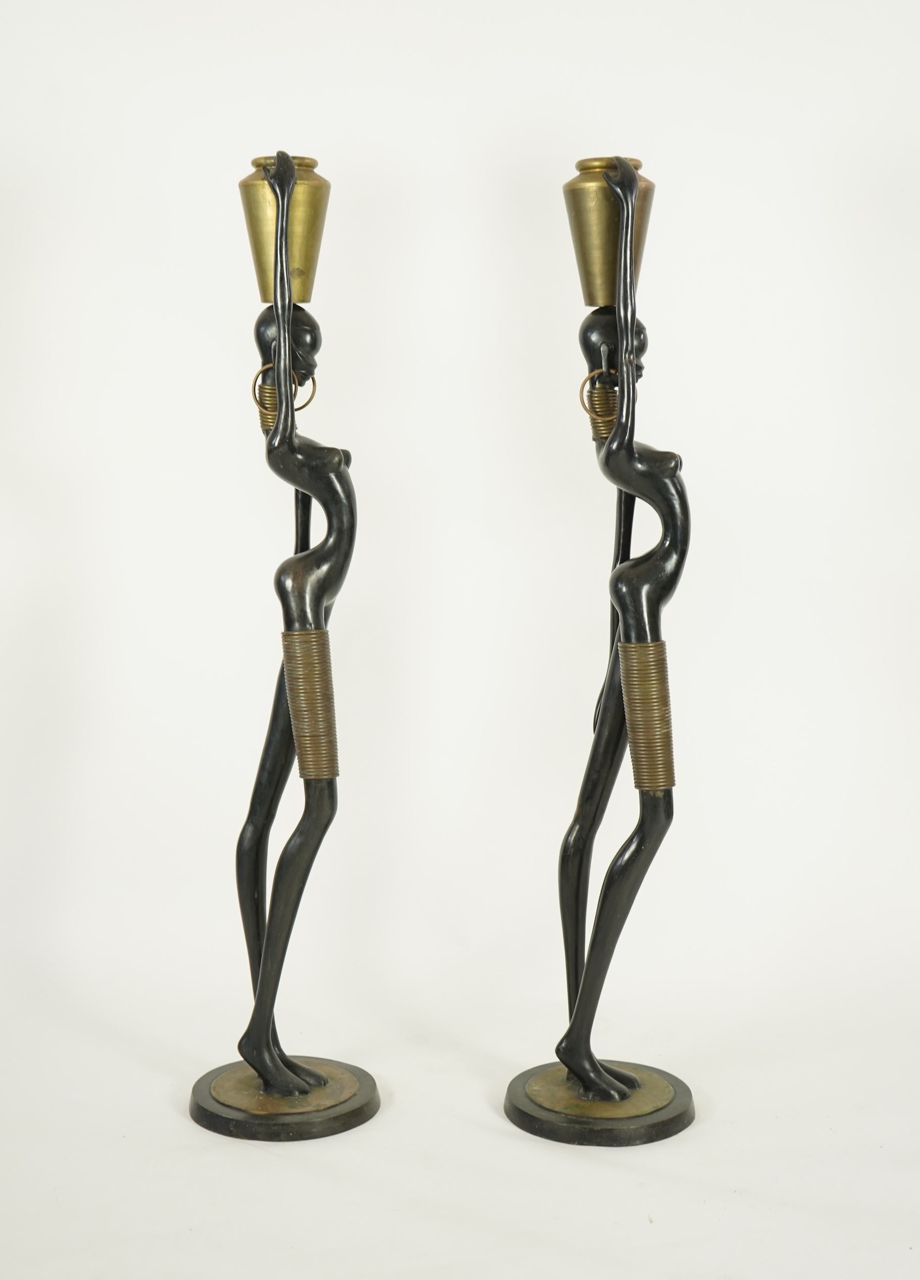 A large pair of Hagenauer style ebonised bronze 'Giraffe Woman' figures